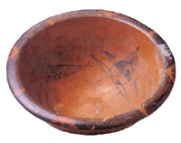 Painted pottery plate with design of fish and human face